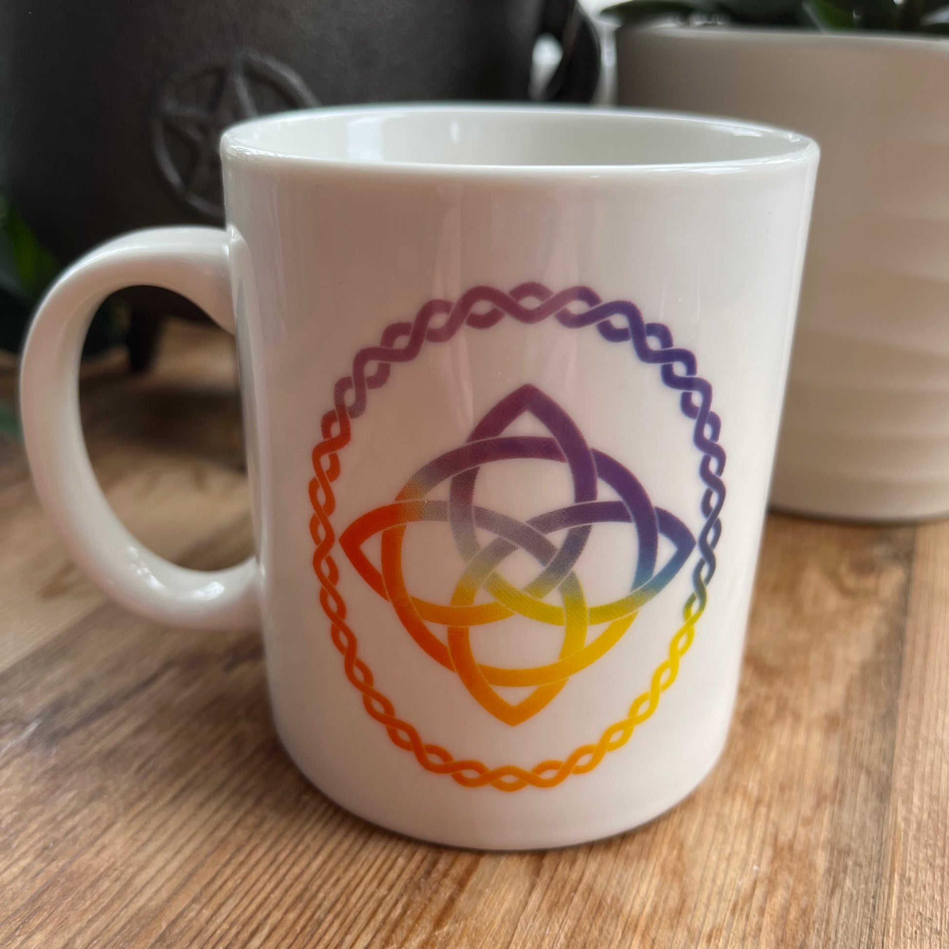 White mug with a Celtic Knot design on  both sides. 