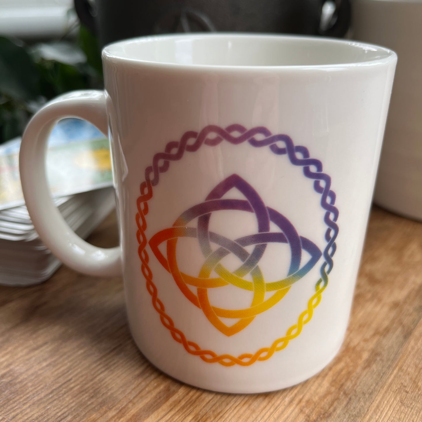 White mug with a Celtic Knot design on  both sides. 