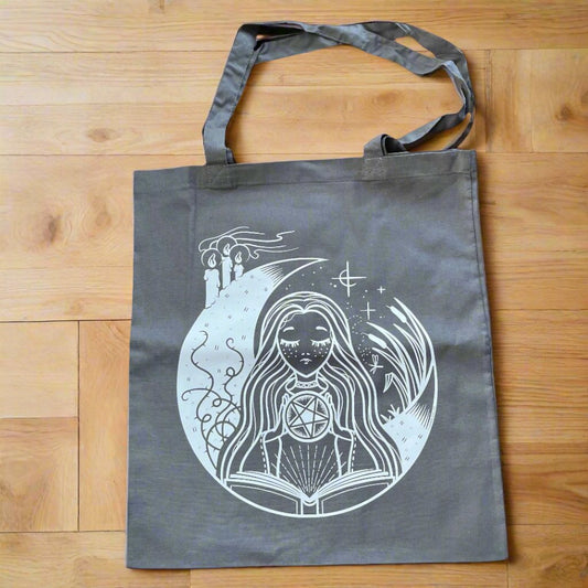 Grey Tote bag with a white Ghaphic depicting a white witch 