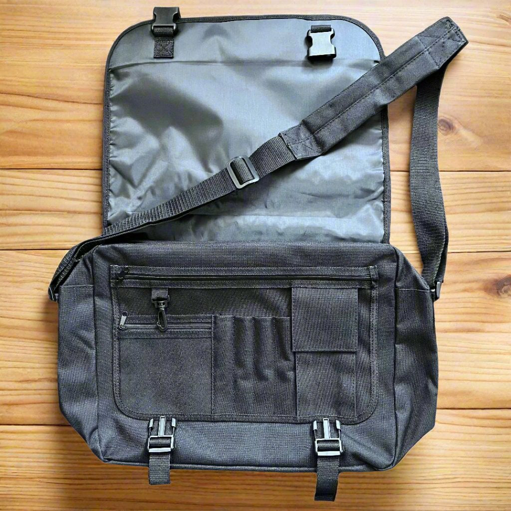 front compartment of the messener bag shows lots of different compartments and zipped pockets 