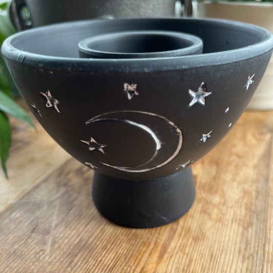 Rustic Black Terracota bowl designed to hold herbs and smudge sticks while burning. Has a white painted moon and stars motif on the side