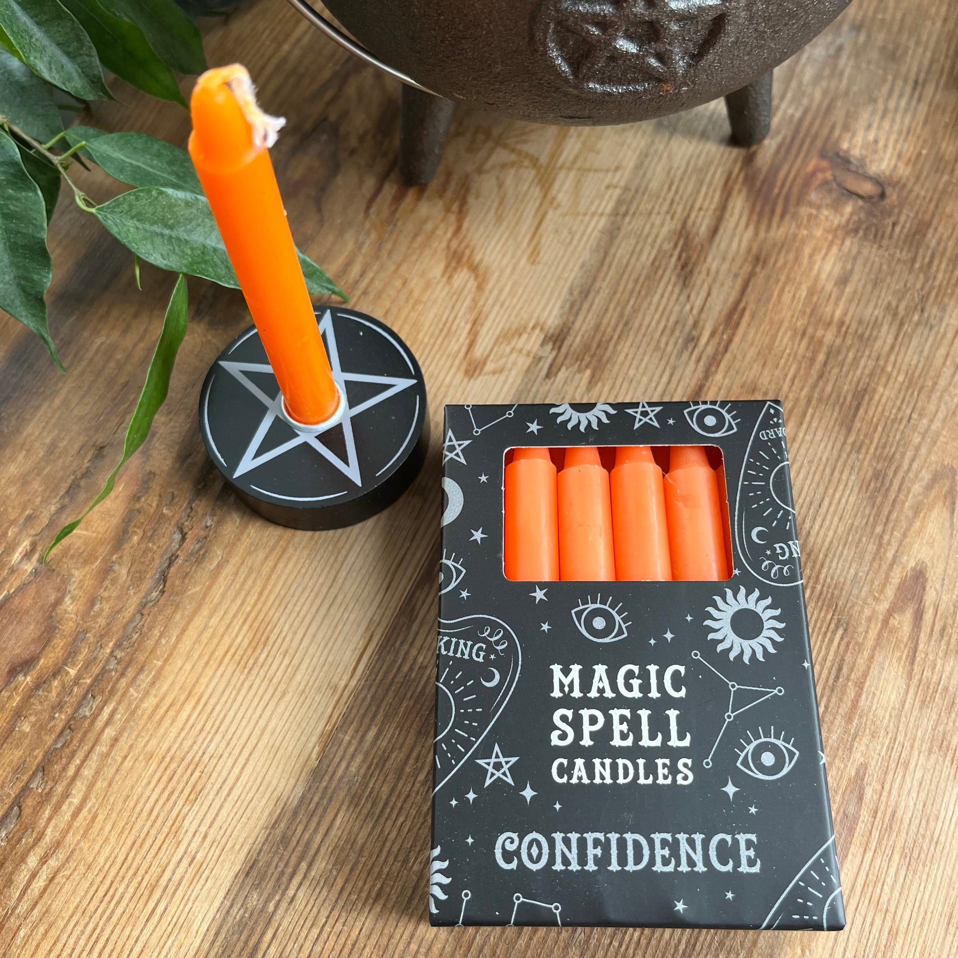 Black box containing 12 orange spell candles the box read magic spell candles for confidence