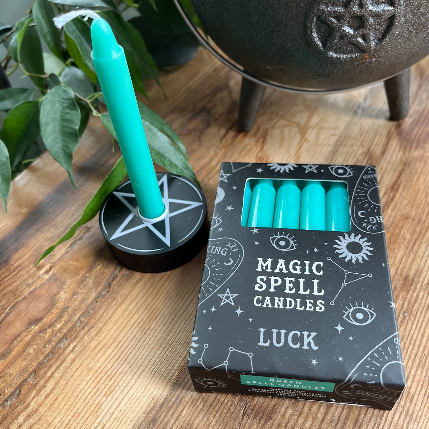 Black box Green containing 12 spell candles the box reads magick spell candles for luck