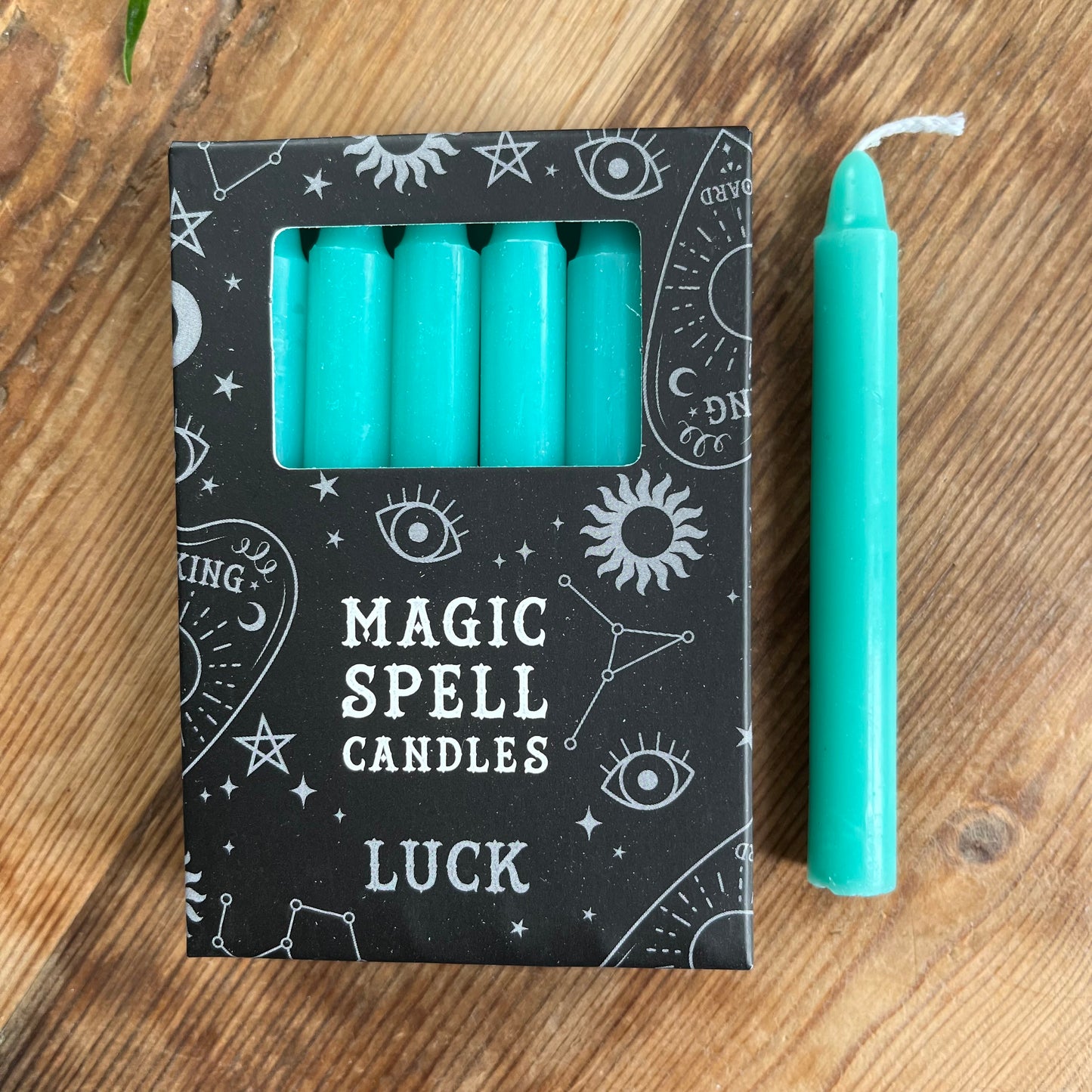 Black box Green containing 12 spell candles the box reads magick spell candles for luck