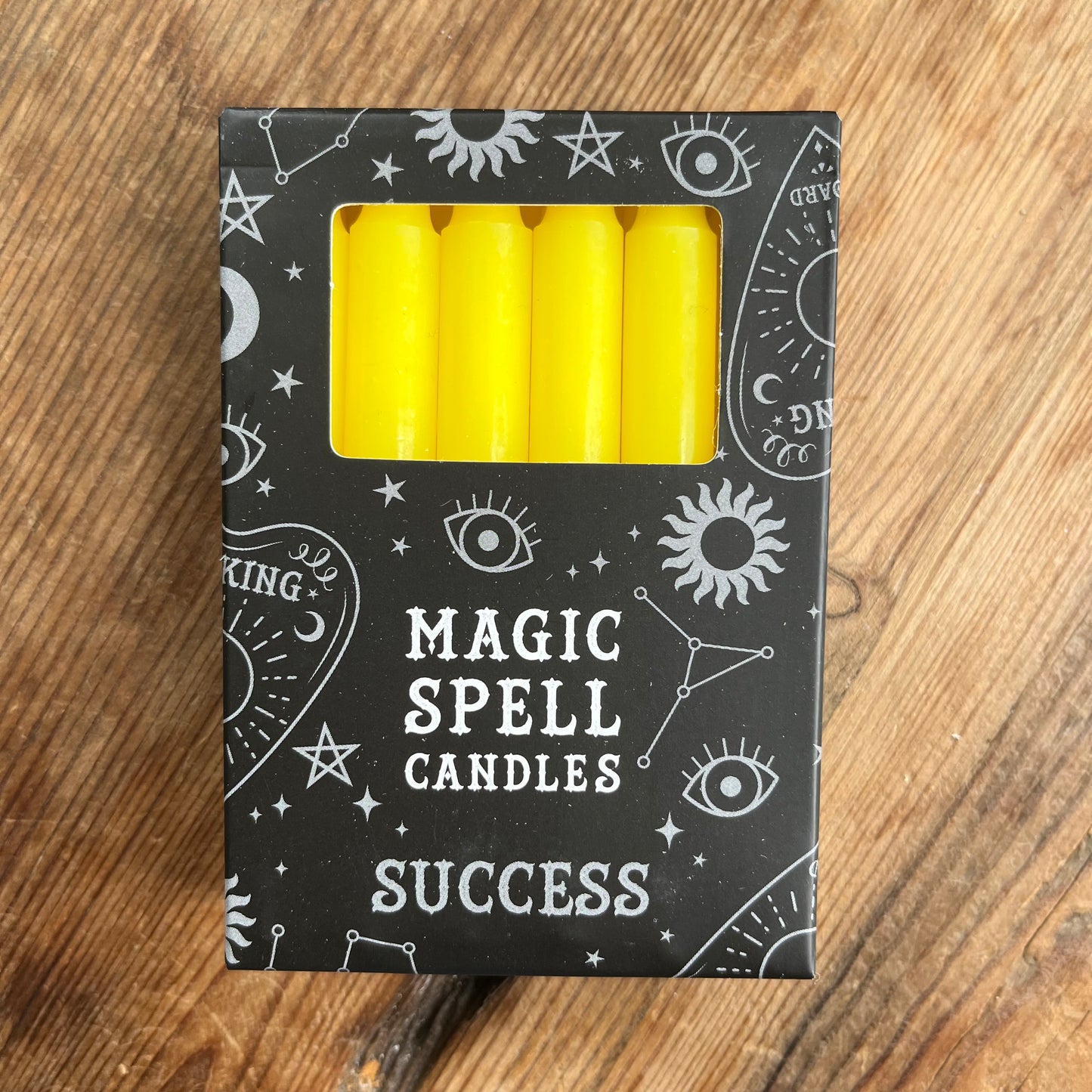 Black box containing 12 yellow spell candles the box reads magic spell candles for success