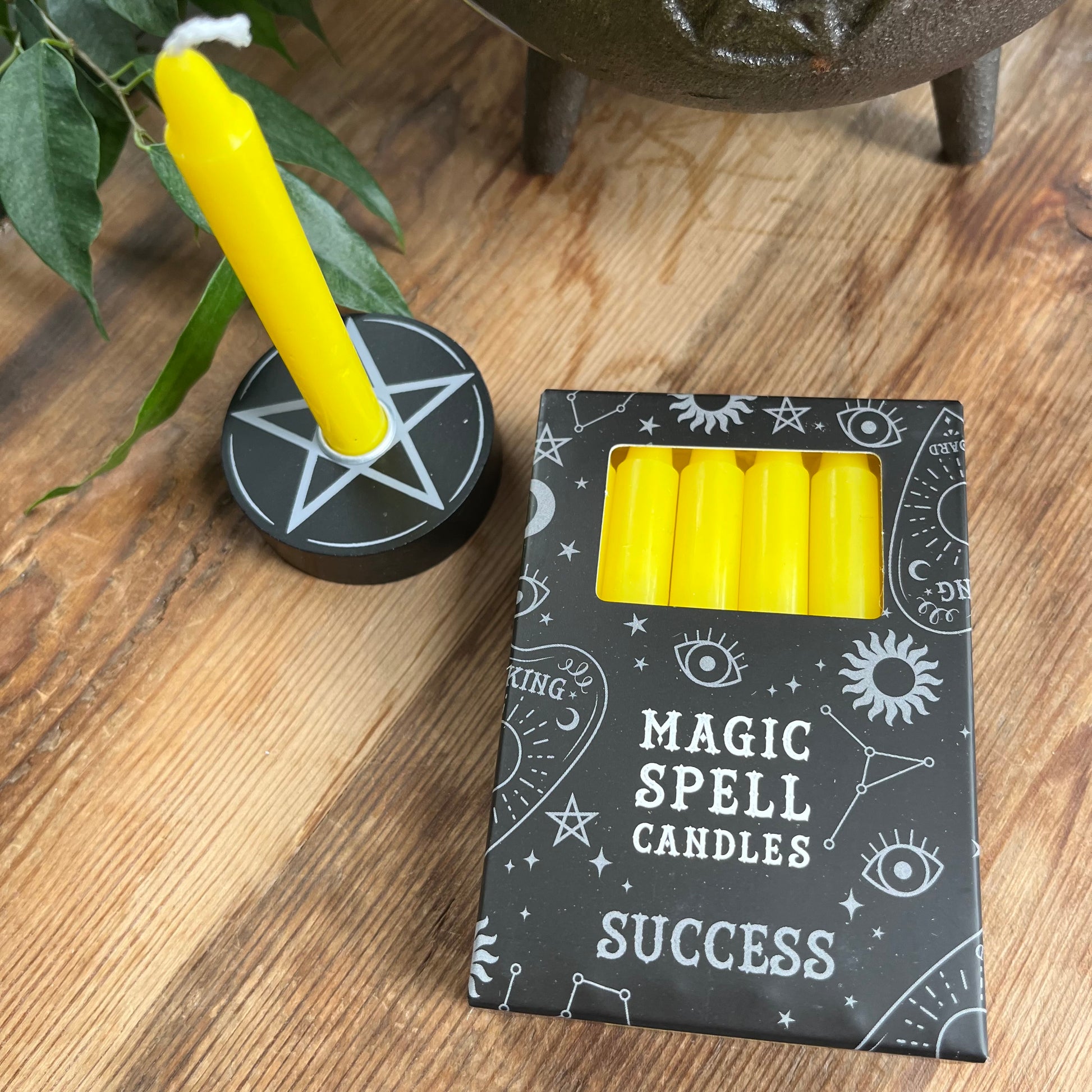 Black box containing 12 yellow spell candles the box reads magic spell candles for success