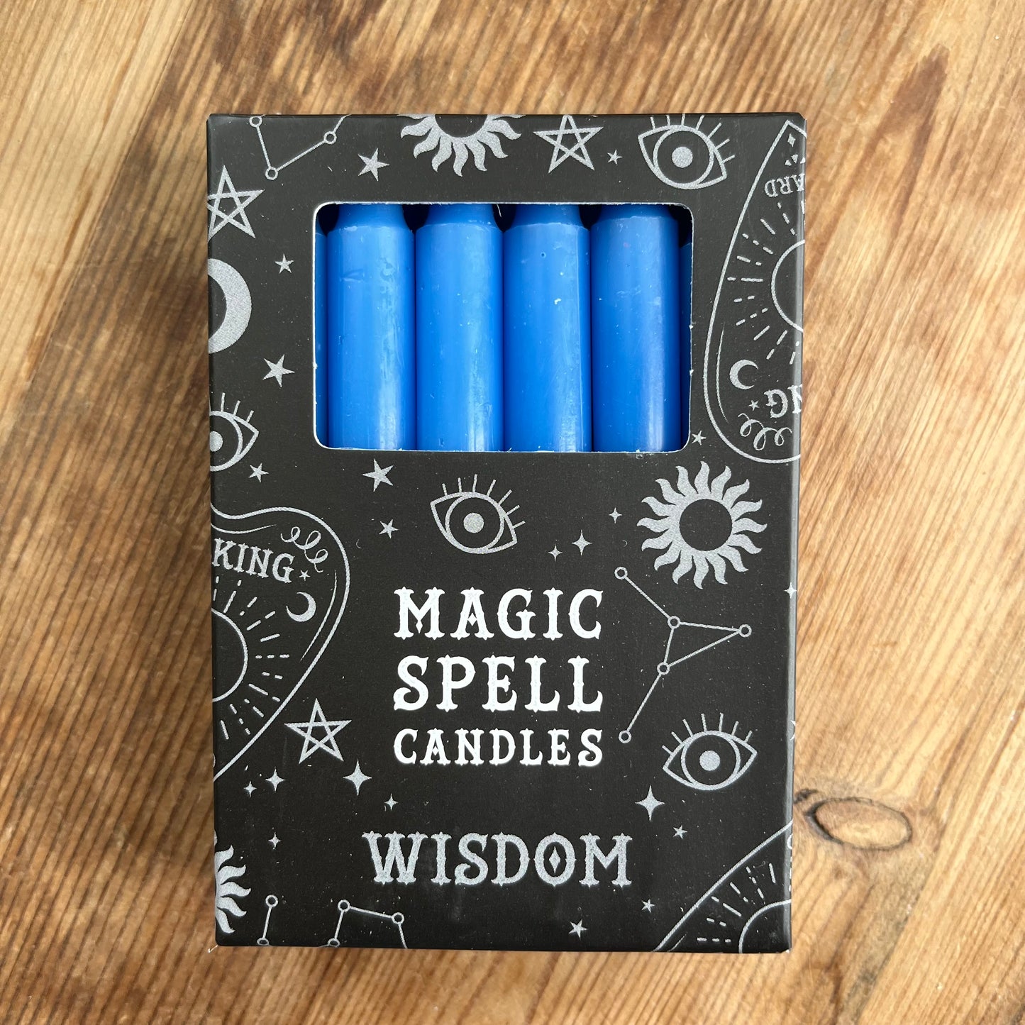 Black box containing 12 dark blue spell candles the box reads magic spell candles for wisdom 