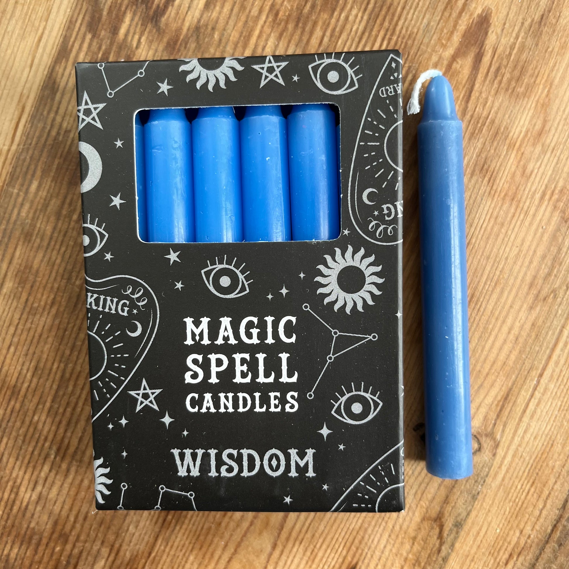 Black box containing 12 dark blue spell candles the box reads magic spell candles for wisdom 