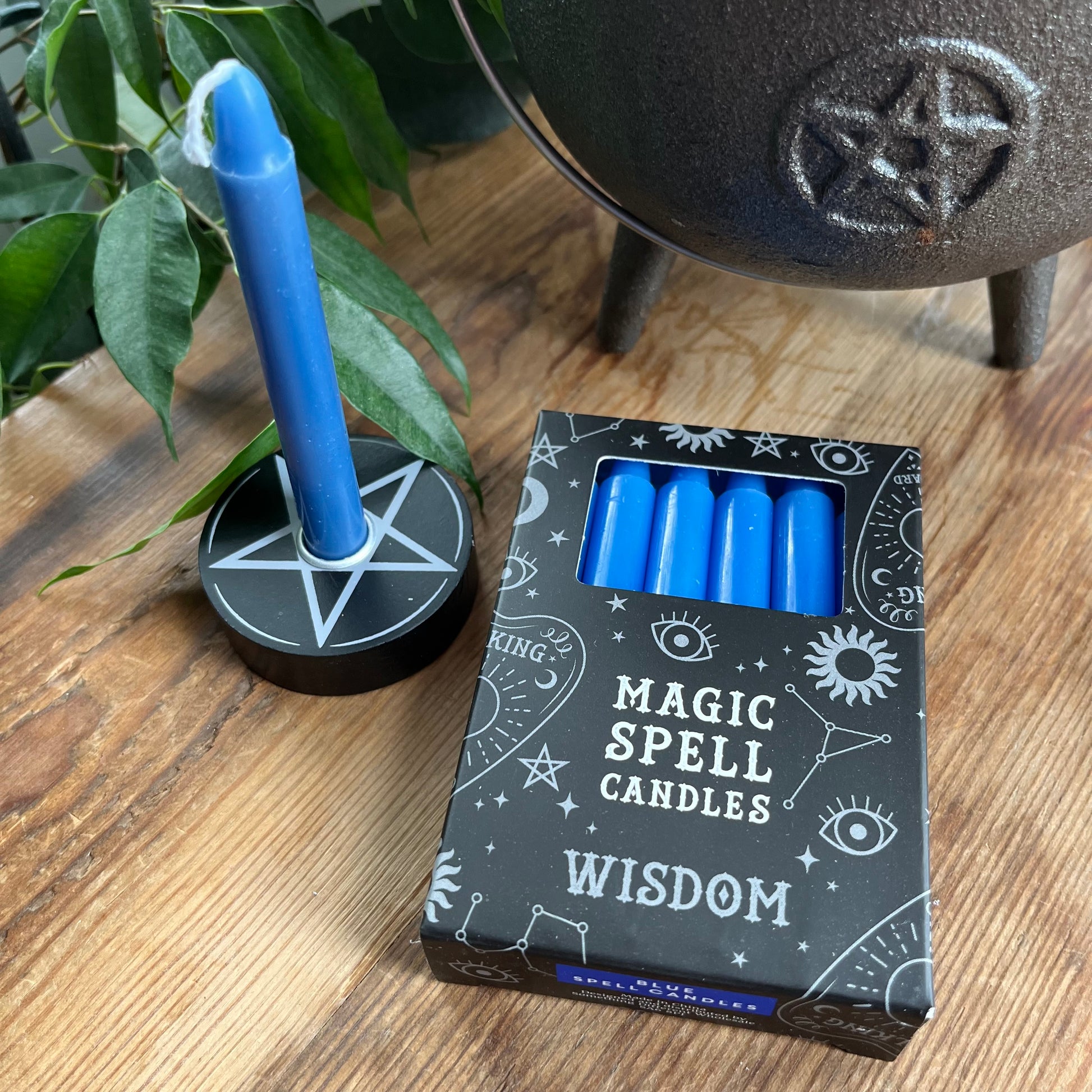 Black box containing 12 dark blue spell candles the box reads magic spell candles for wisdom 