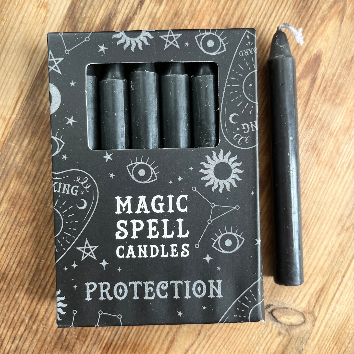 Black box containing 12 black spell candles, box reads magic spell candles for protection