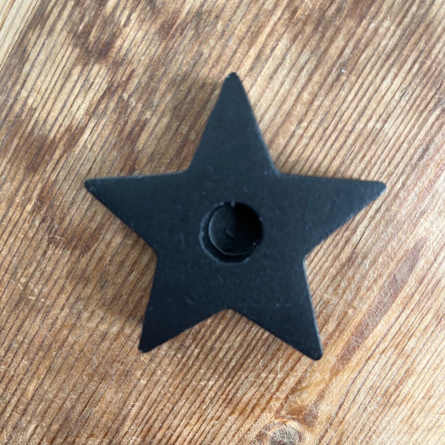 Black wooden candle spell holder in the shape of a star