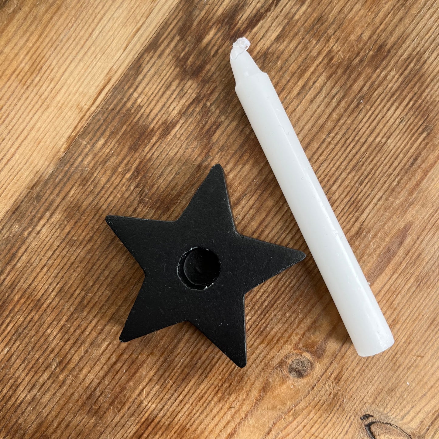 Black wooden candle spell holder in the shape of a star