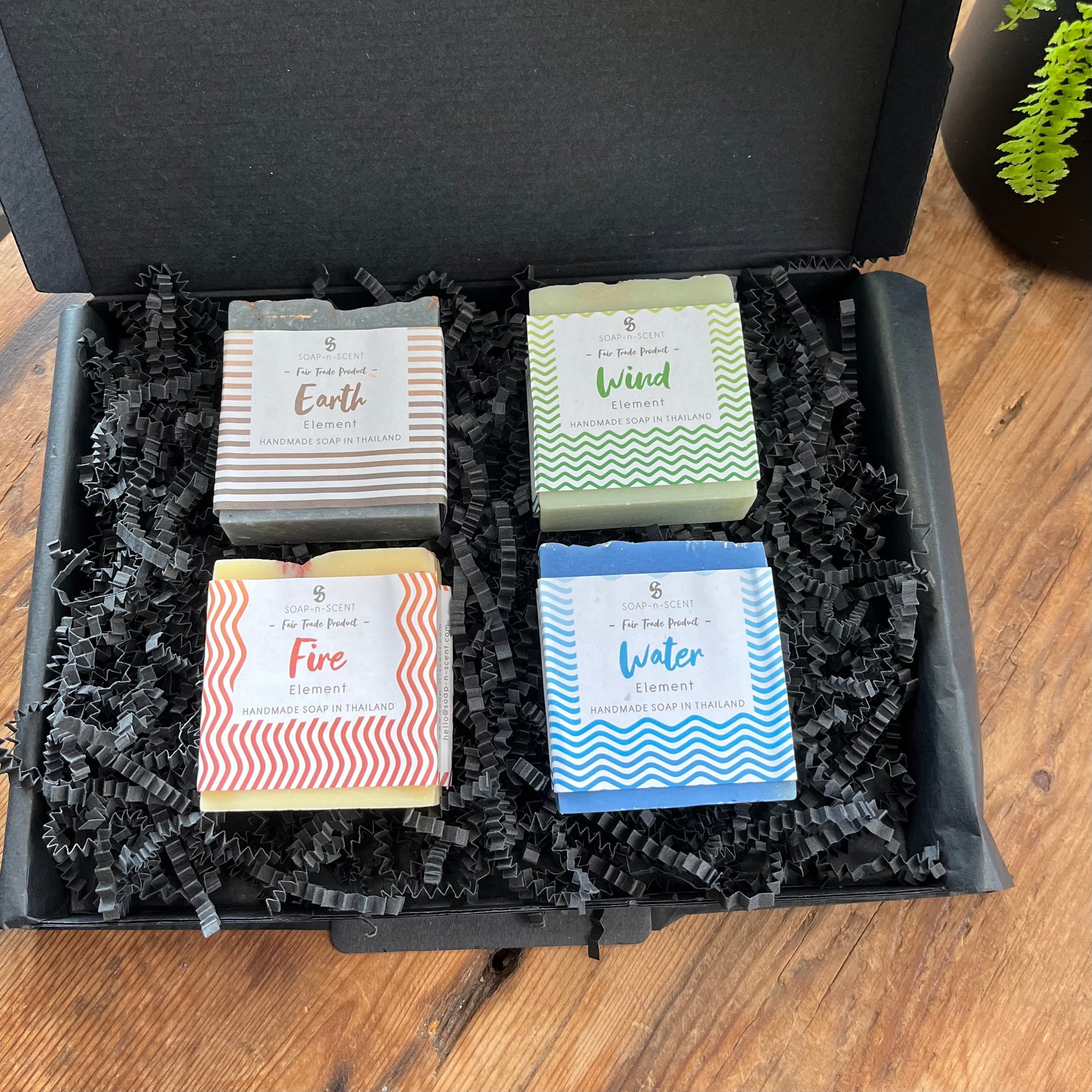 4 square shaped bars of soap for each of the 4 elements of earth, air, fire and water. Presented in a black letterbox gift sized box. 