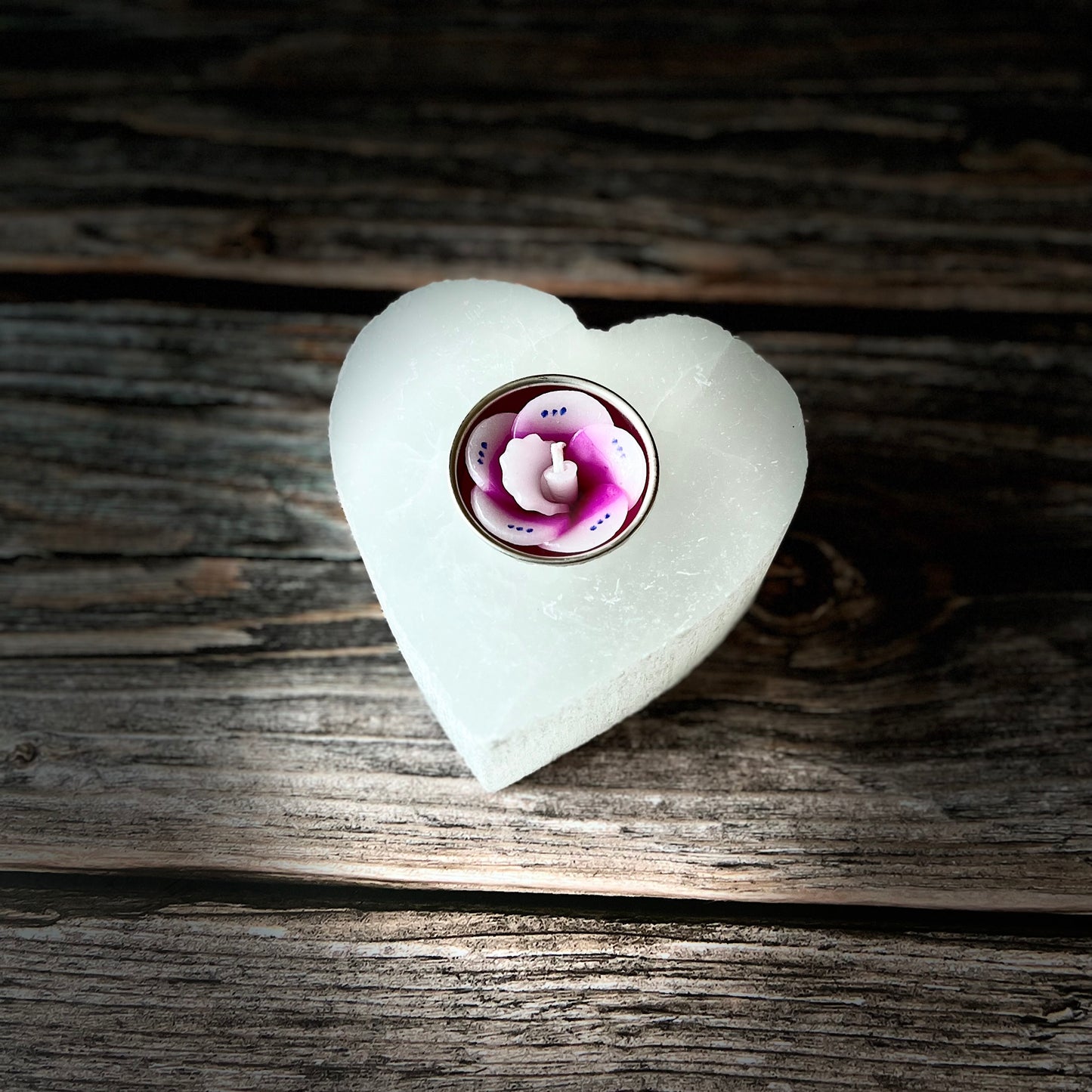 Selenite  carved heart tealight holder  glowing white in the light