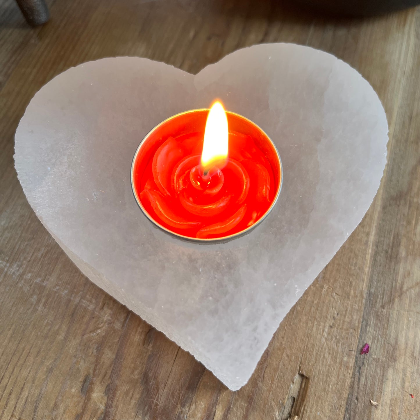 Chunky piece of natural selenite carved into a heart shape tealight holder.