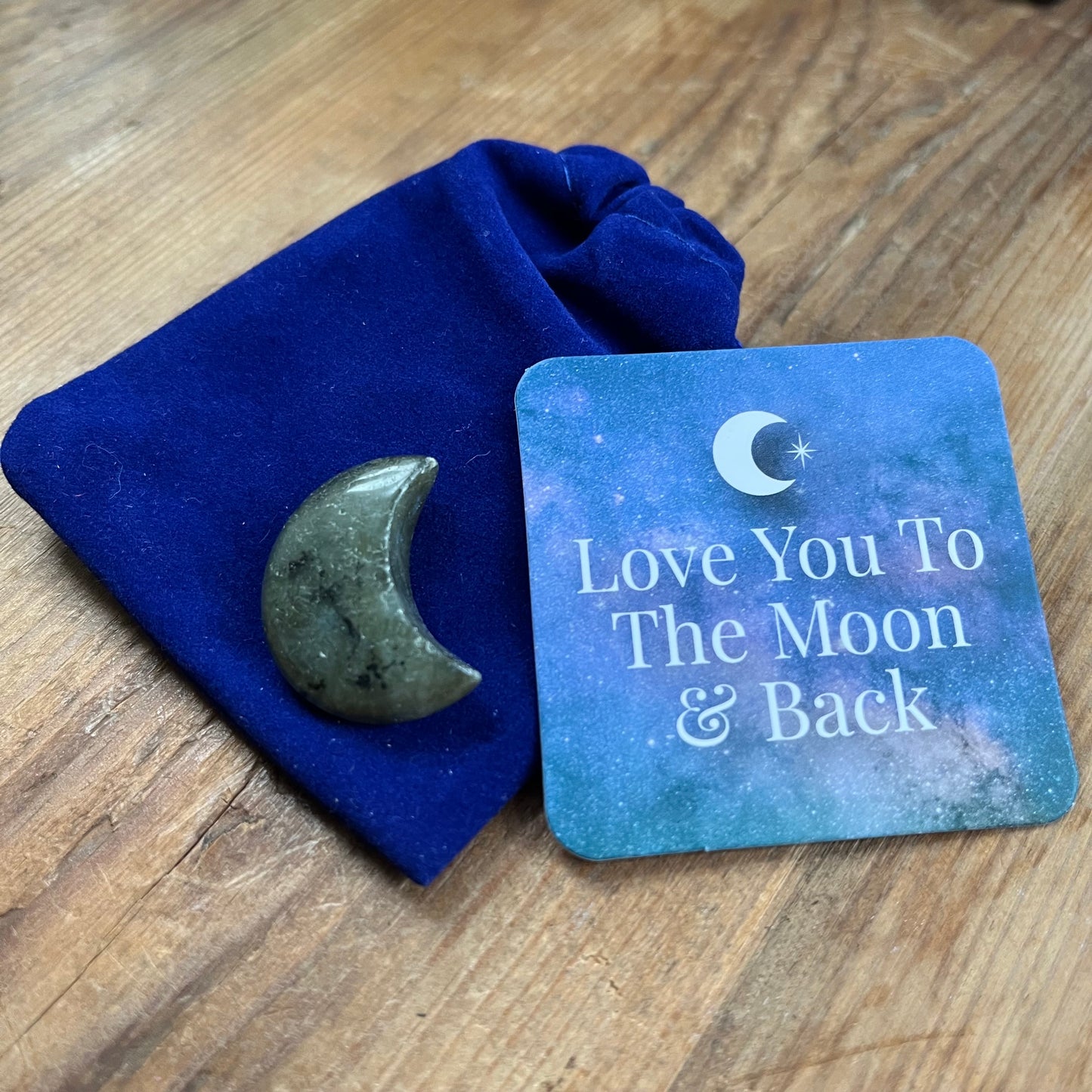 Blue velvet pouch, Labradorite crescent shaped moon and a blue sentiment card with an image f a white crescent moon and the words 'Love you to the moon and back"