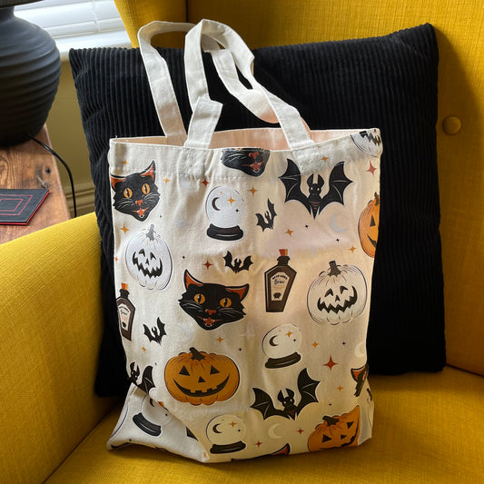 Tote bag with Halloween designs on a yellow couch