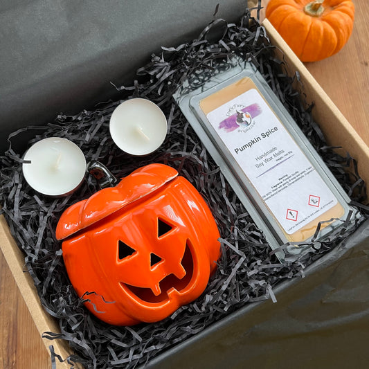 Halloween-themed gift set with pumpkin-shaped 0il burner and wax melt bar in a box.