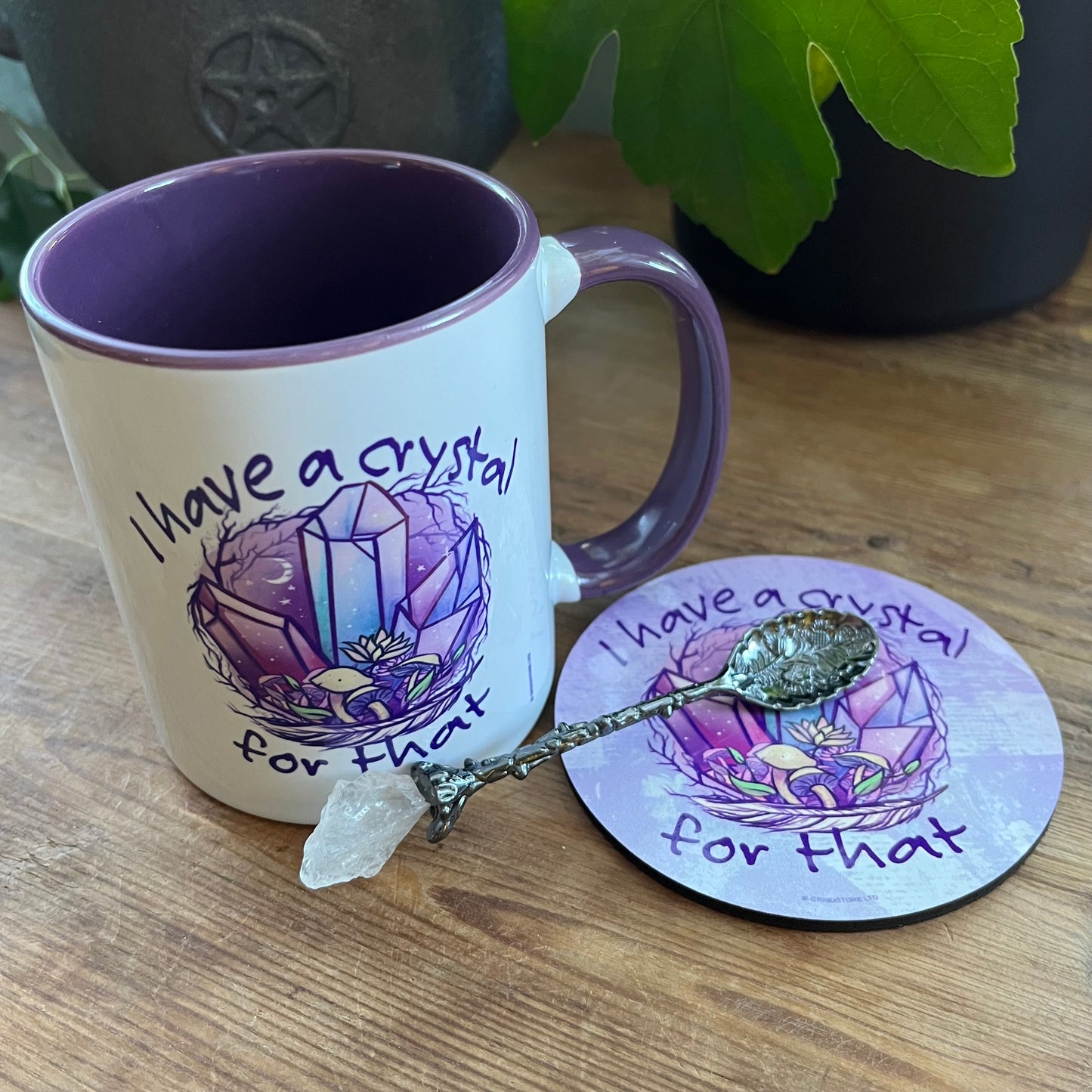 Mug and coaster set with crystal design and text on a wooden surface