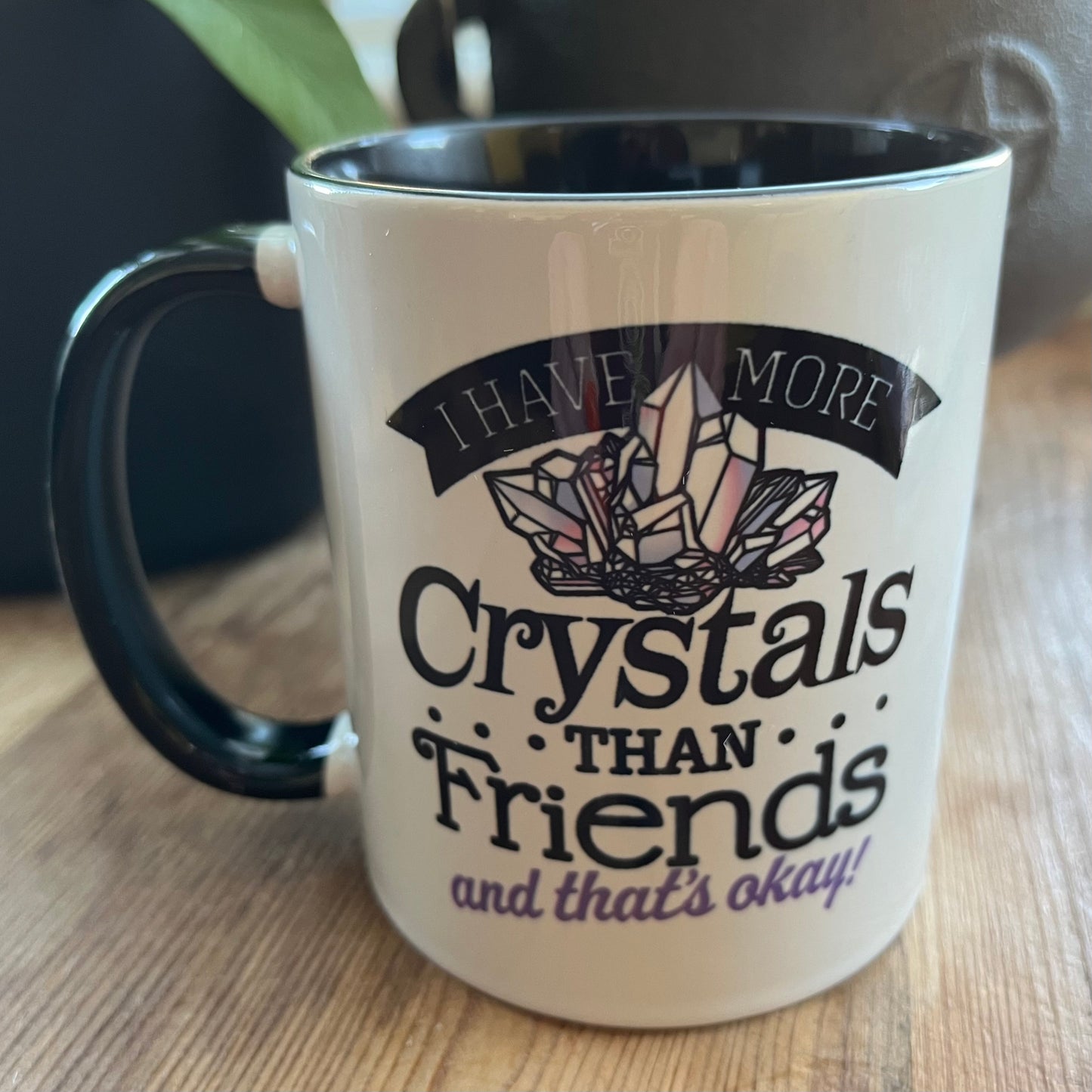Mug with crystal design and text on a wooden surface