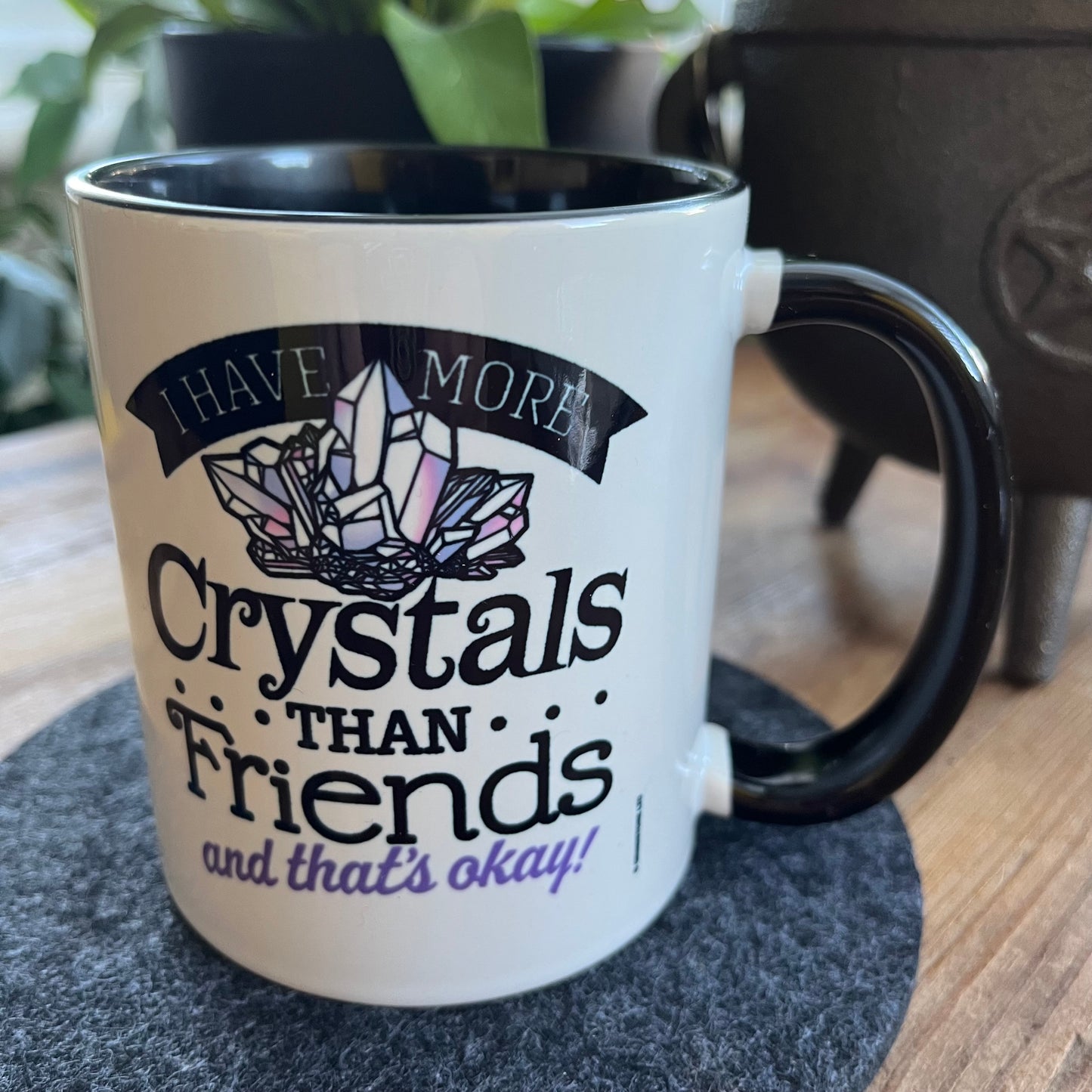 Mug with crystal-themed text on a coaster