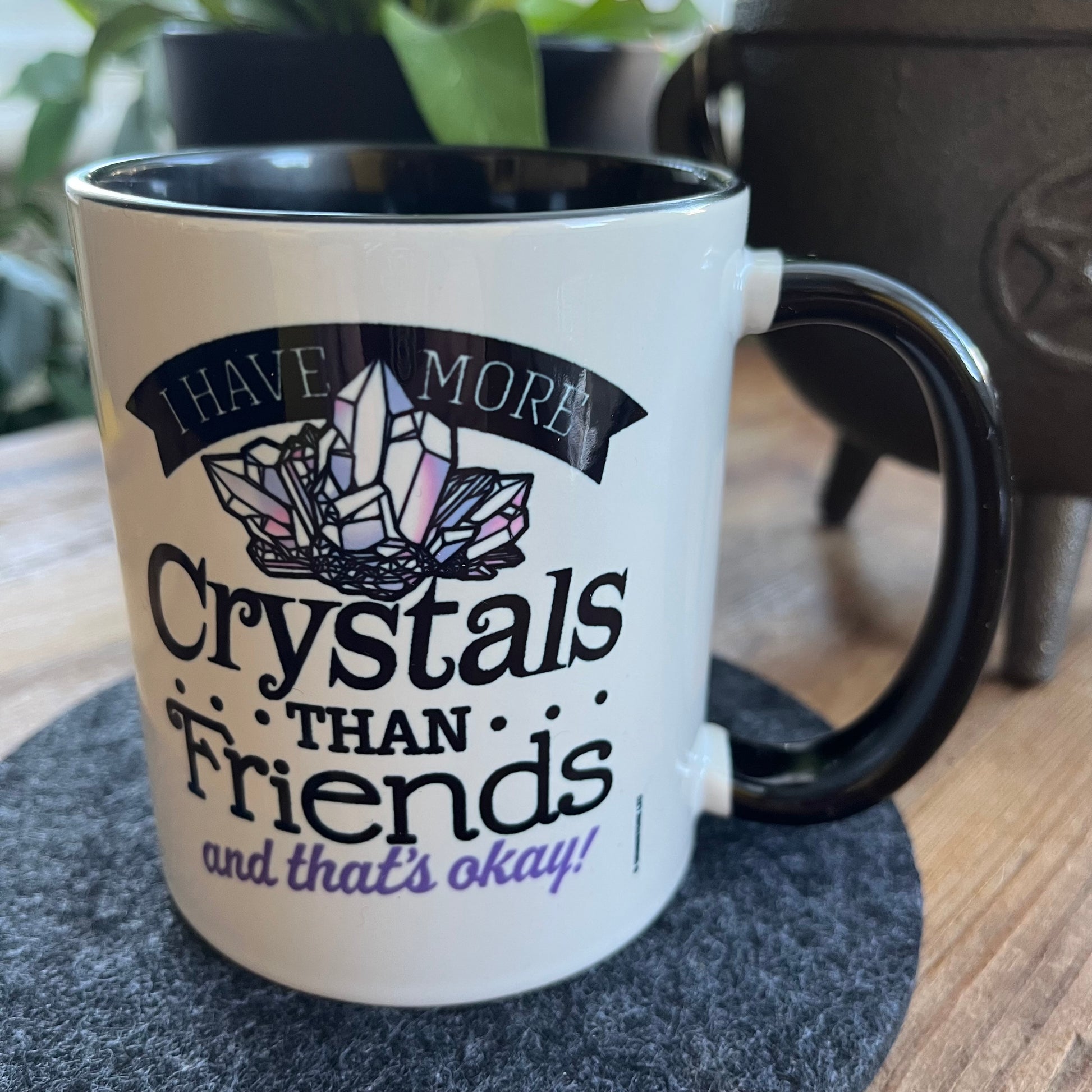 Mug with crystal-themed text on a coaster