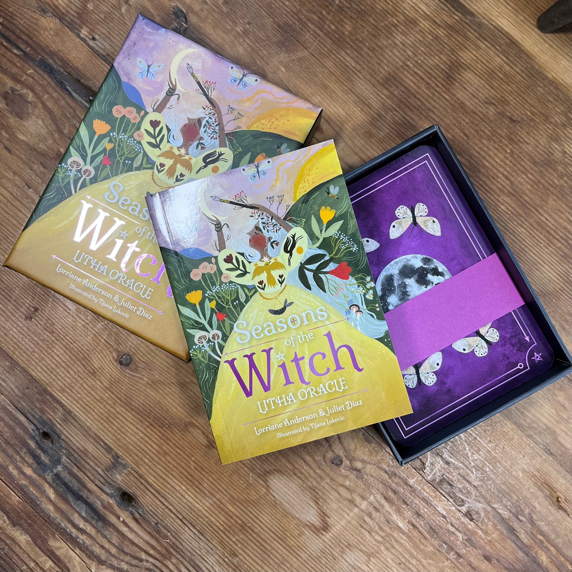 Seasons of the Witch oracle book and cards on a wooden surface