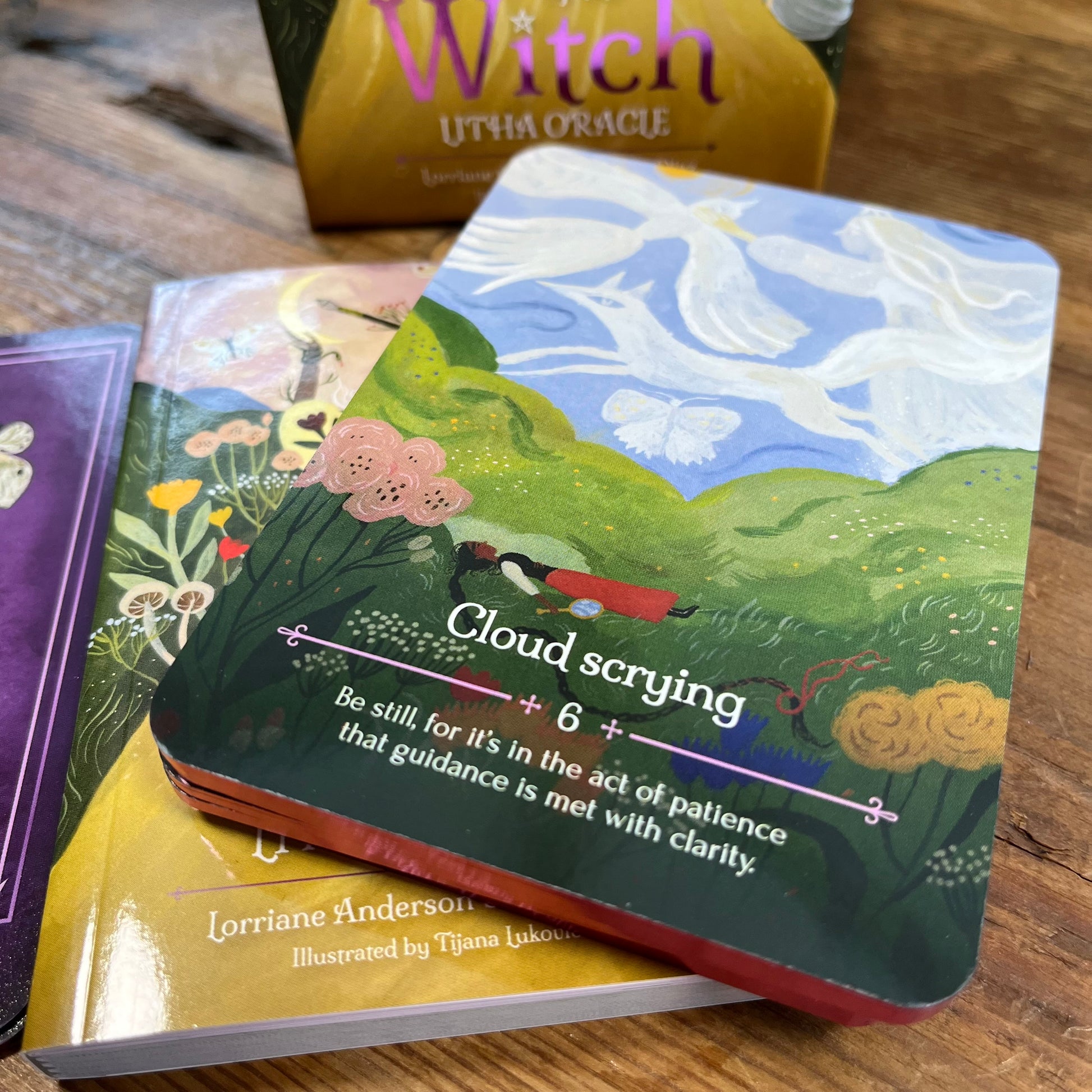 Oracle Card with nature-themed illustration and text on a wooden surface