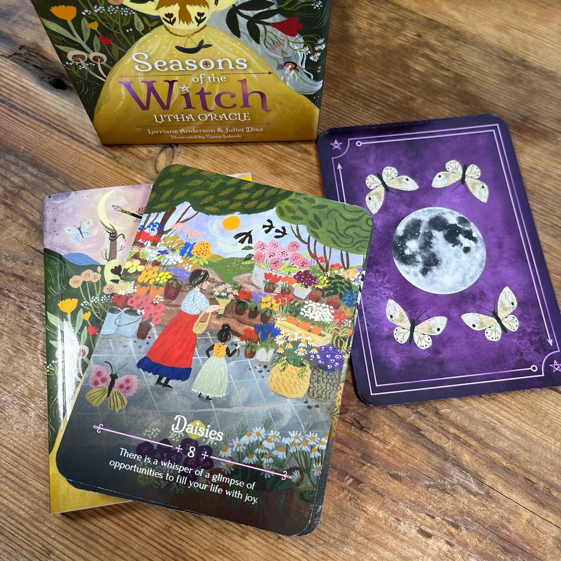 'Seasons of the Witch' with Oracle cards on a wooden surface