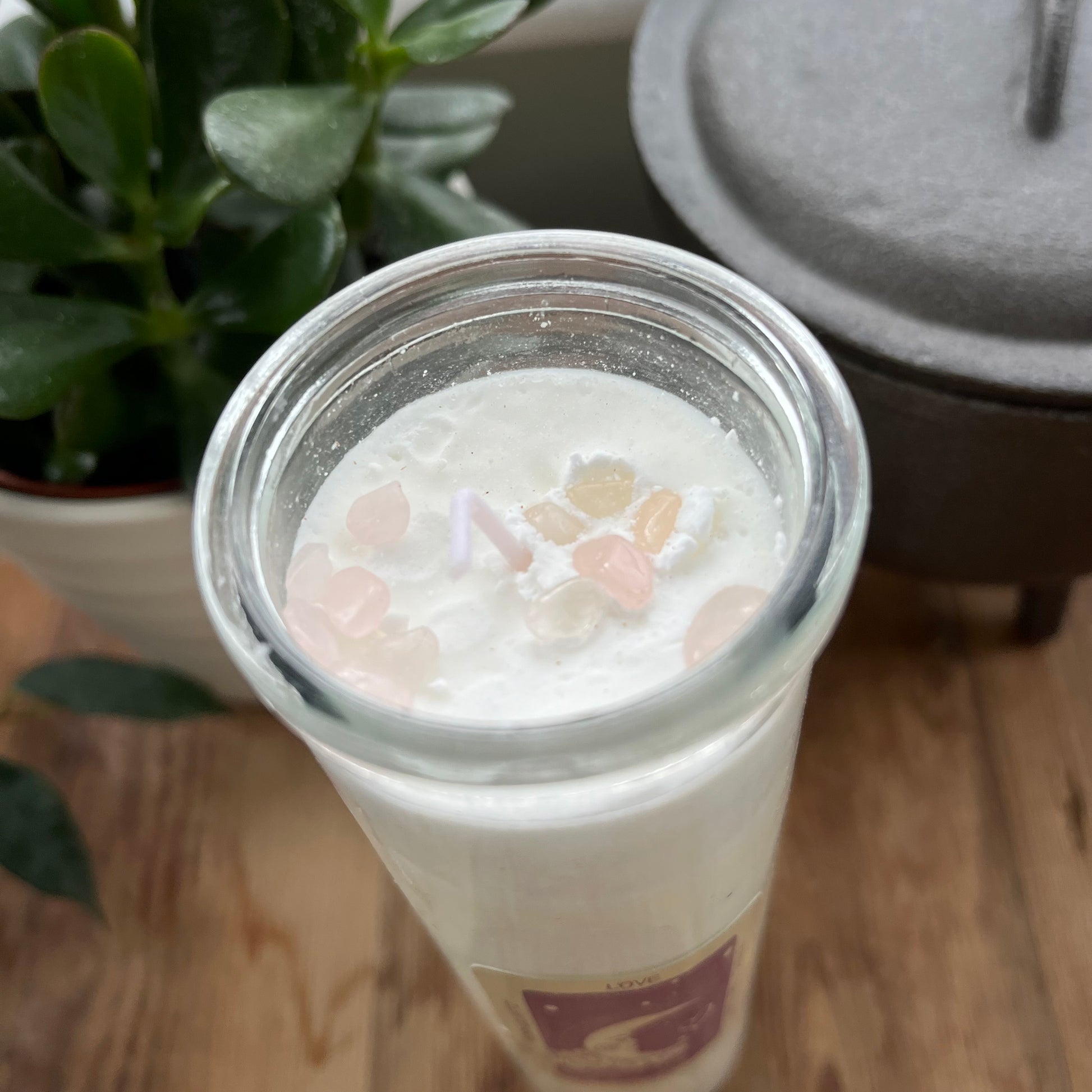 An over head view of the rose quartz crystals embedded within the love spell candle 