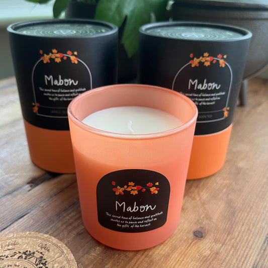Candle with 'Mabon' label on a wooden surface
