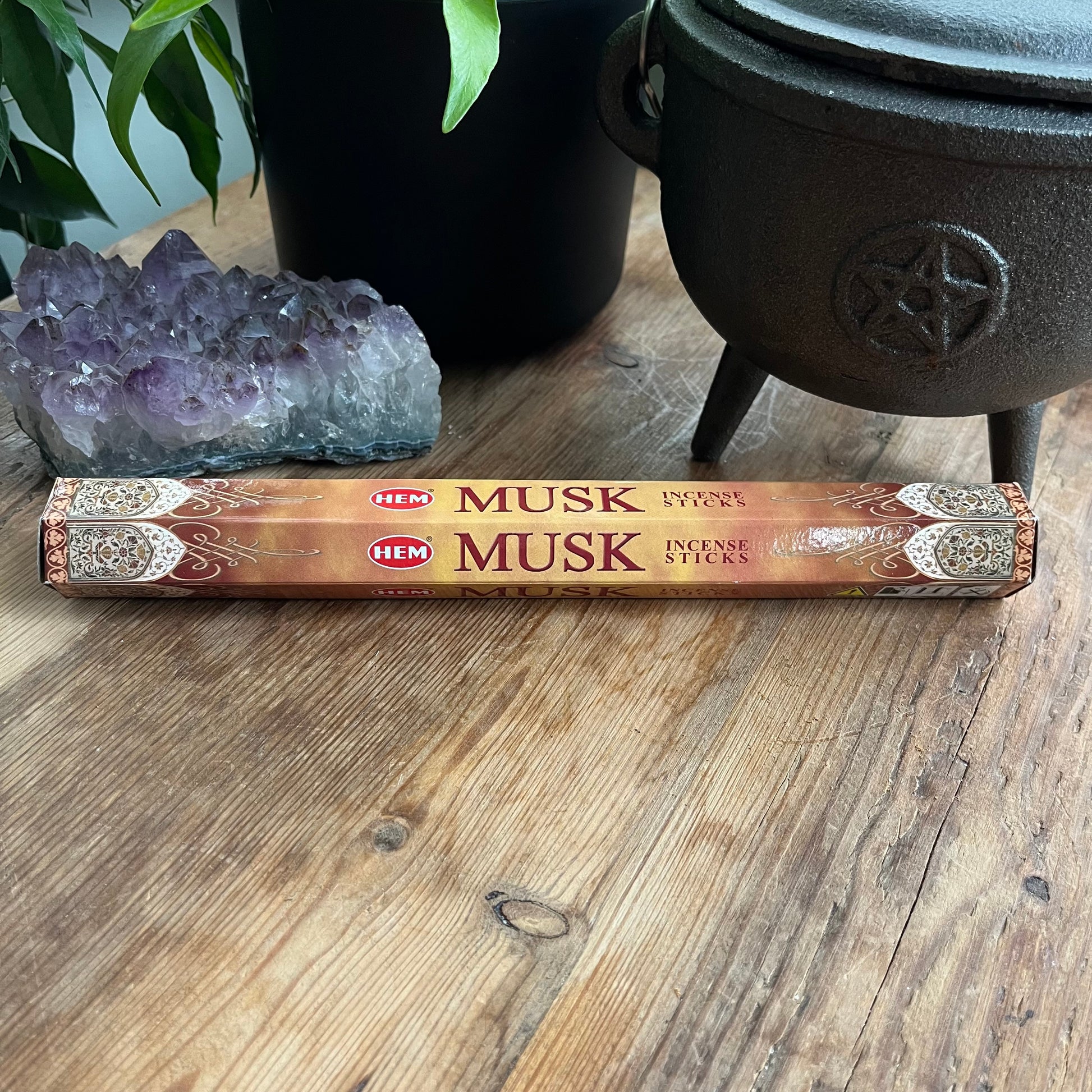 Packet of Musk Hem Incense on wooden table 