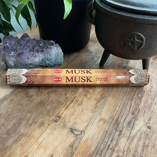 Packet of Musk Hem Incense on wooden table 