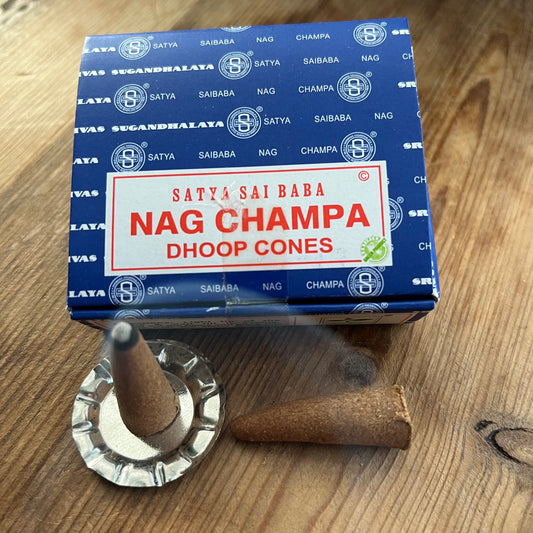 Box of Nag Champa Dhoop incense cones by Satya on wooden surface 