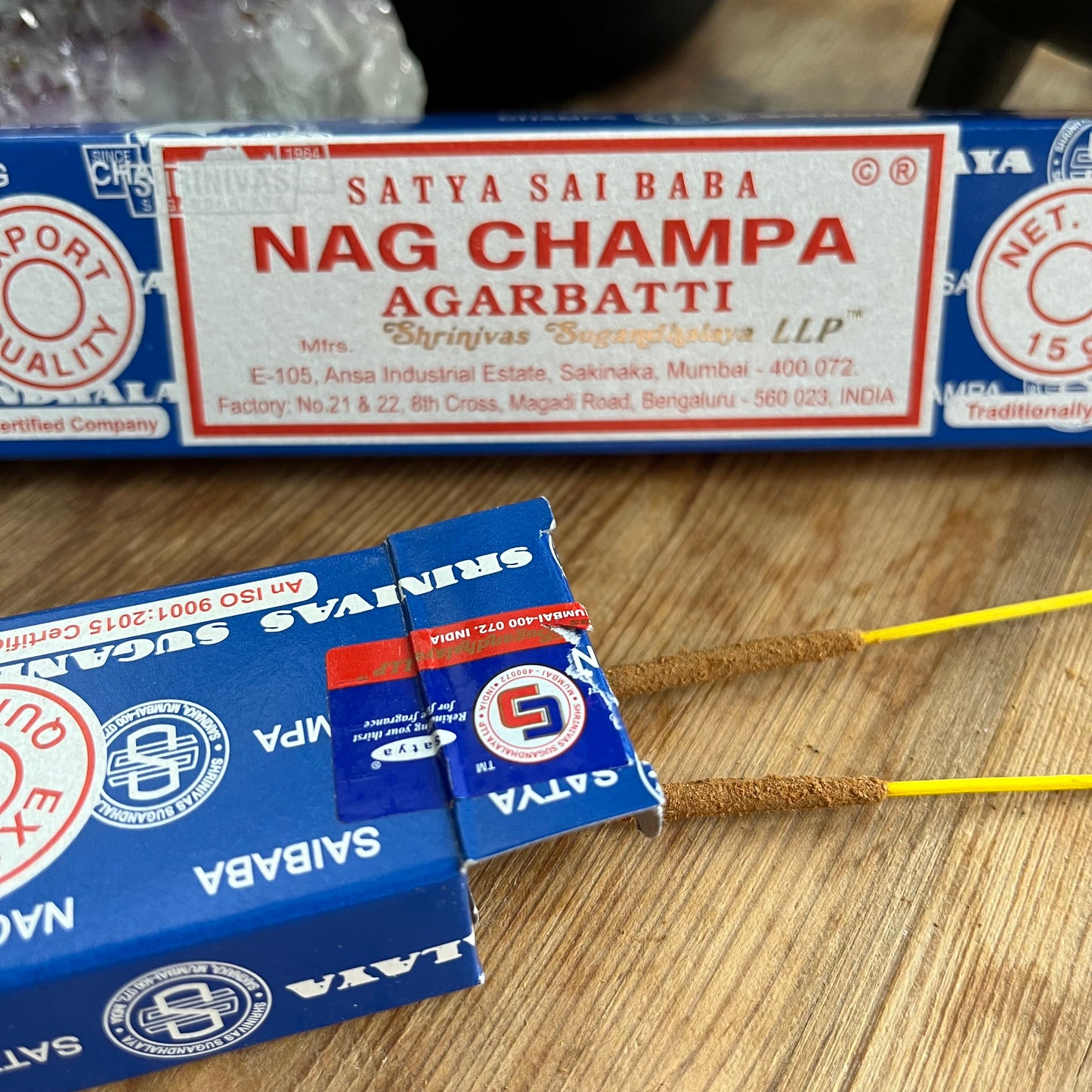 A box of Satya Sai Baba Nag Champa Agarbatti incense sticks displayed on a wooden surface.