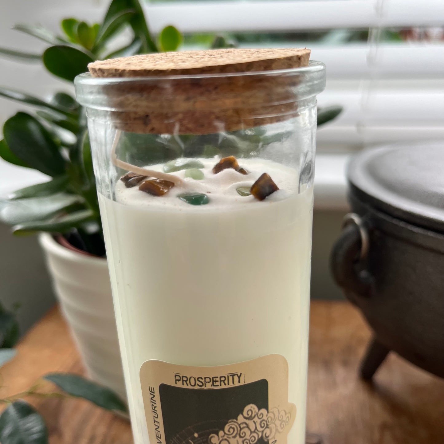 An over head view of the Tigers Eye and Green Aventurine crystals embedded within the prosperity spell candle 