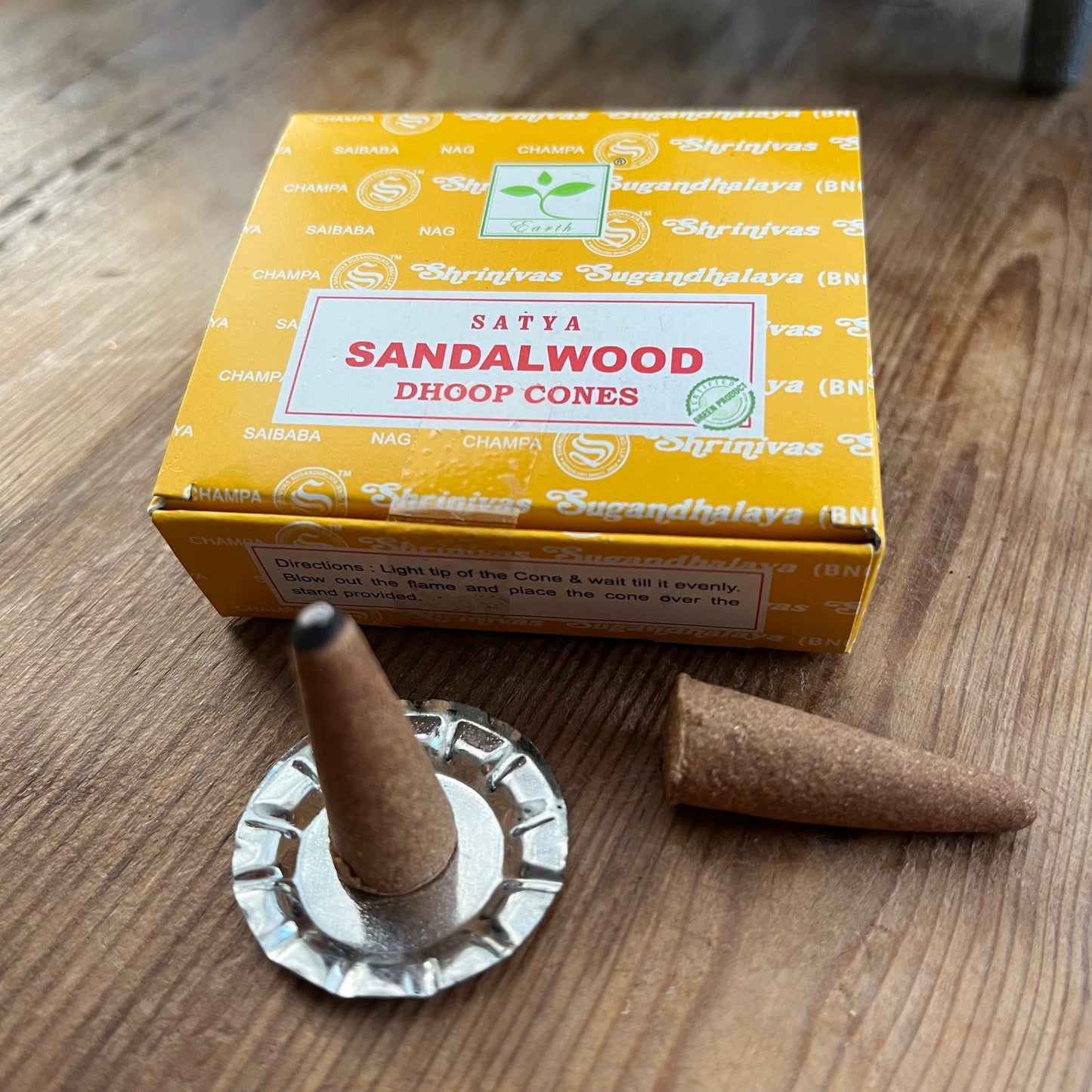 Box of Satya Sandalwood Dhoop incense cones on wooden surface