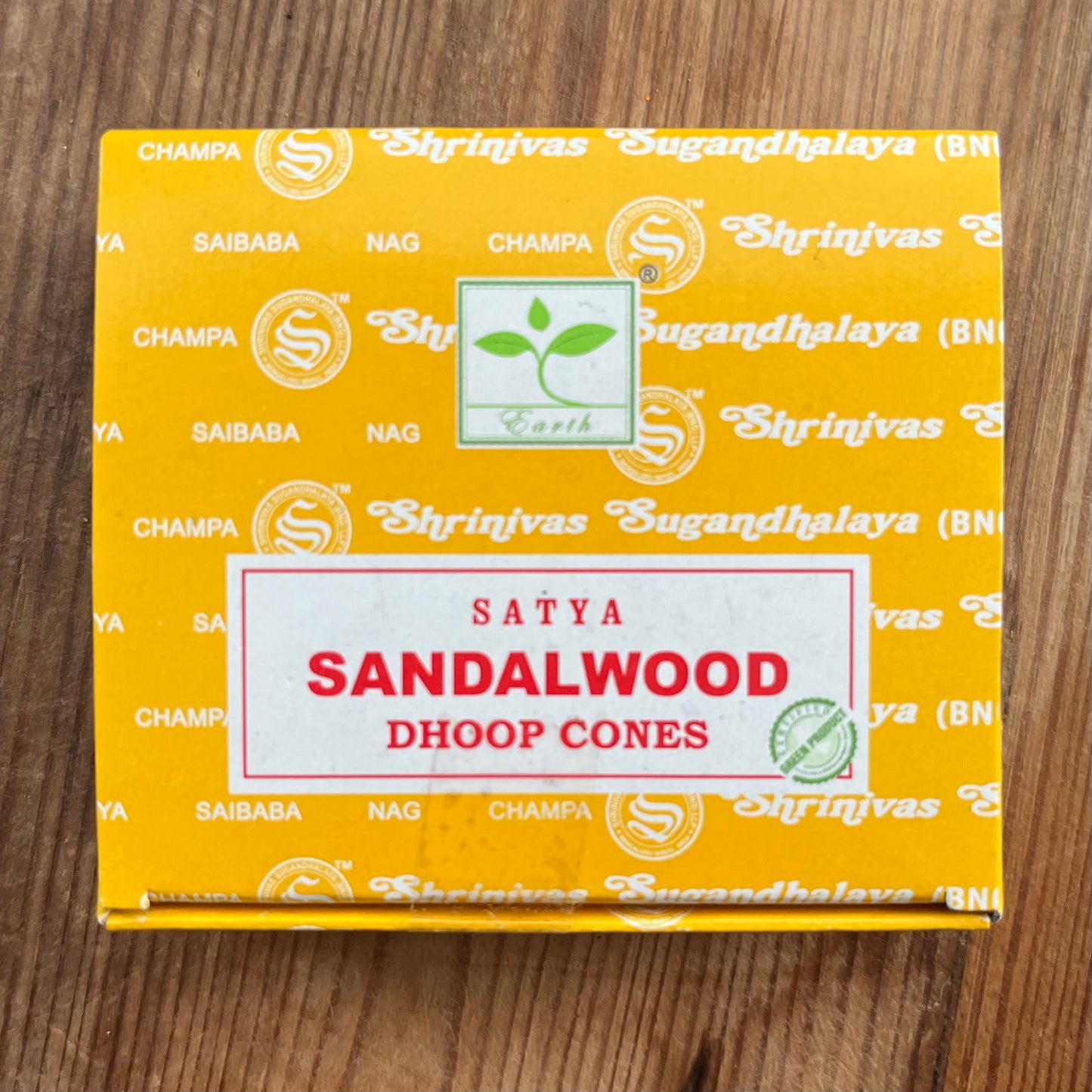 Box of Satya Sandalwood Dhoop incense cones on wooden surface