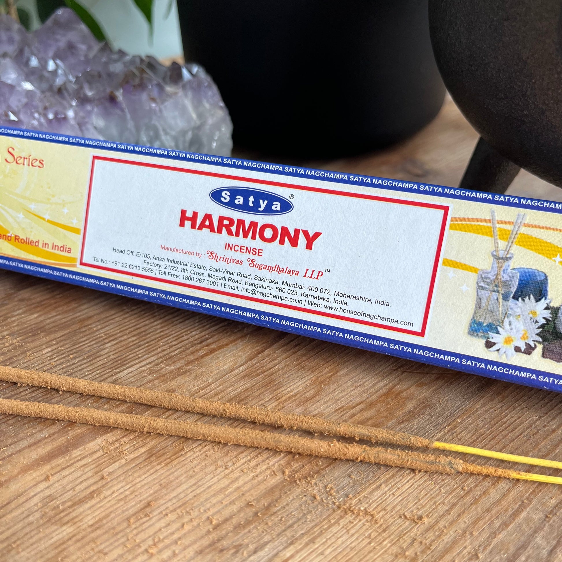 A box of Satya Harmony incense from the Yoga Series, presumably containing essential oil incense sticks for meditation and relaxation. Alongside some loose incense sticks 