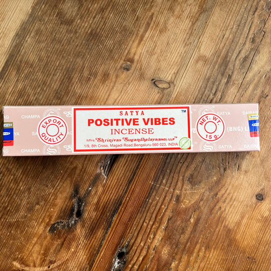 Box of Satya Positive vibes incense on a wooden table 