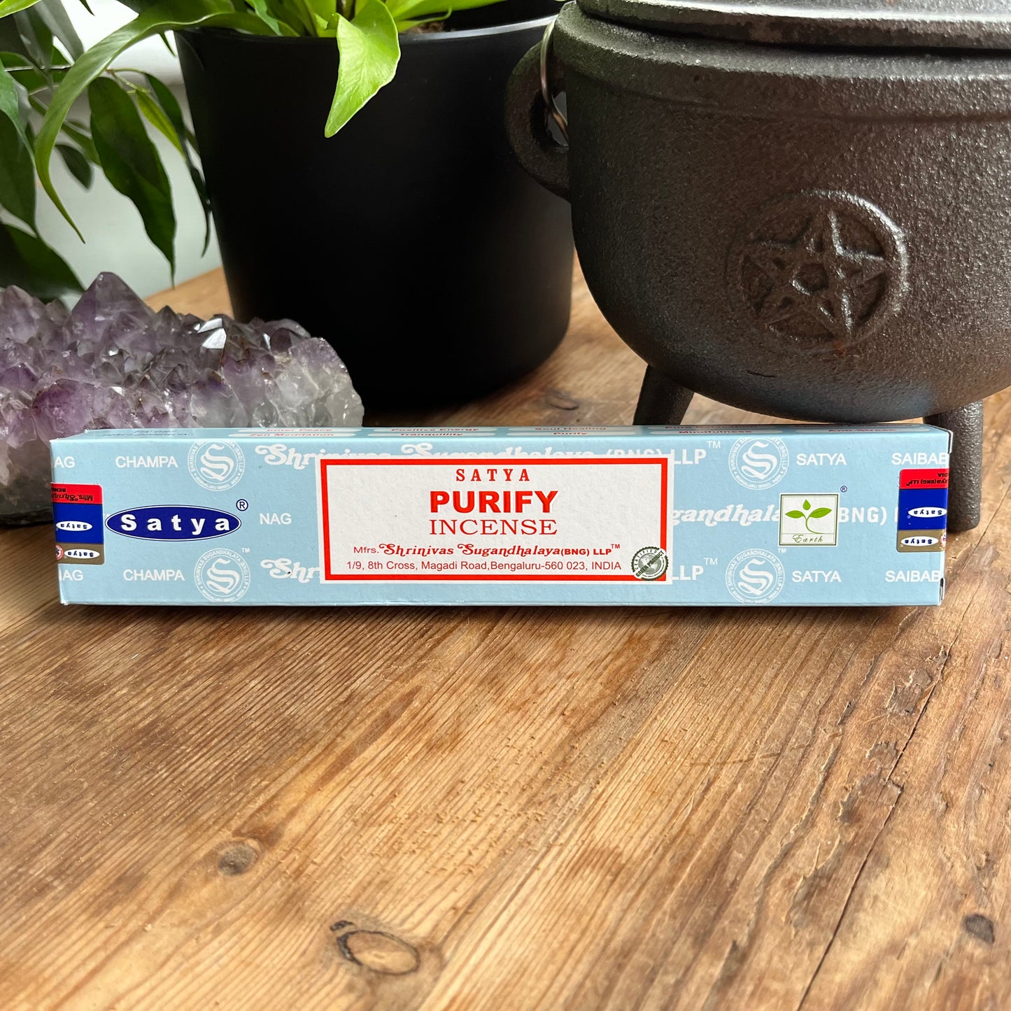A box of Satya Purify incense placed on a wooden surface, with the brand name and product description visible.