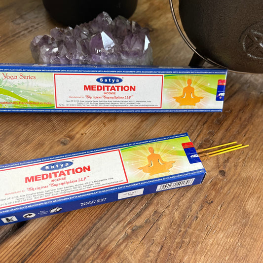 Two Boxes of satya meditation incense. one box is open with the incense peeking out