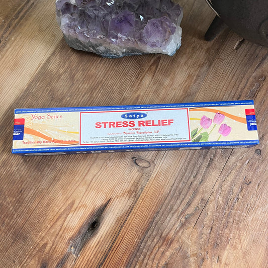 Box of Satya Stress Releif incense on a wooden table with crystal behind 