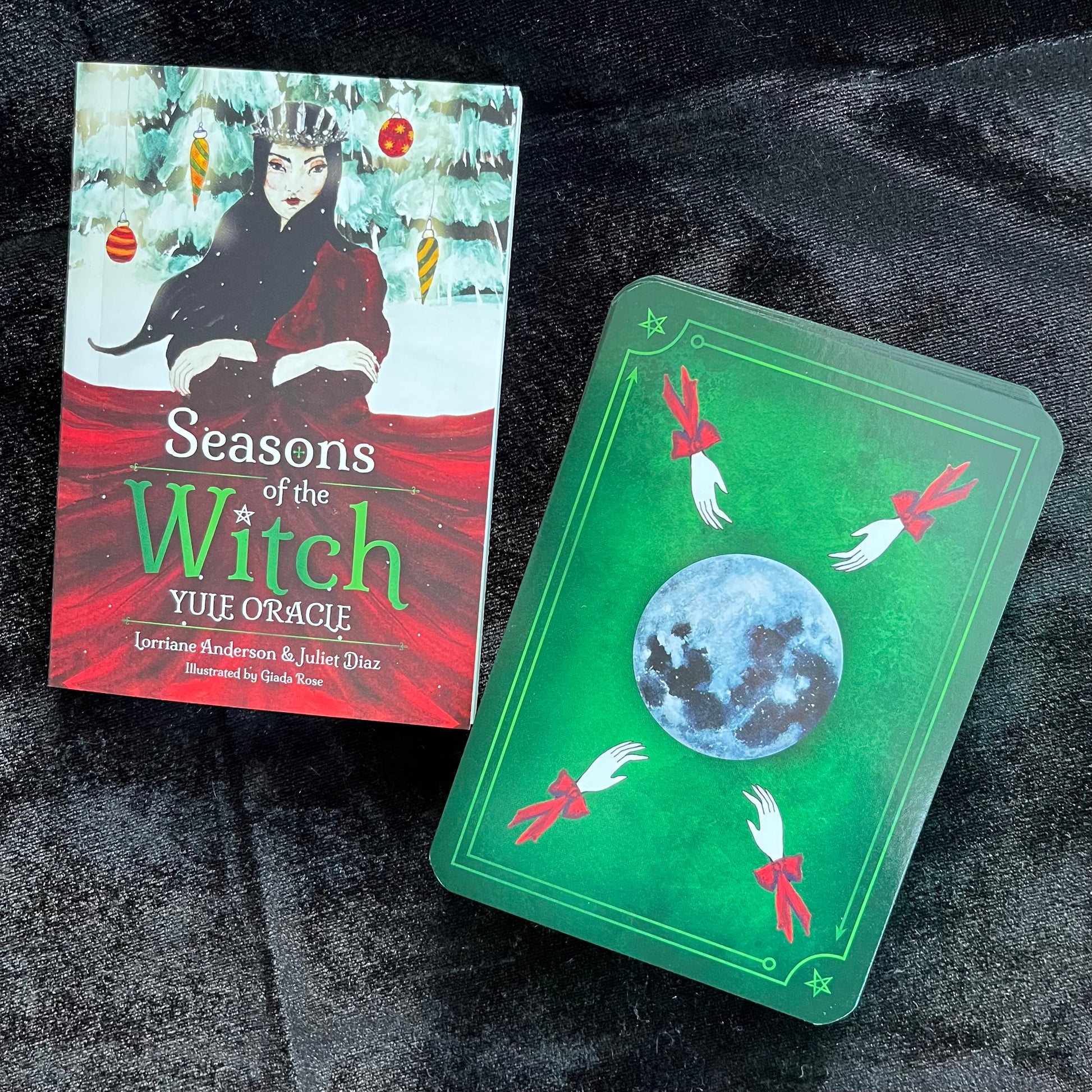 Card game box titled 'Seasons of the Witch Yule Oracle' on a dark textured surface.