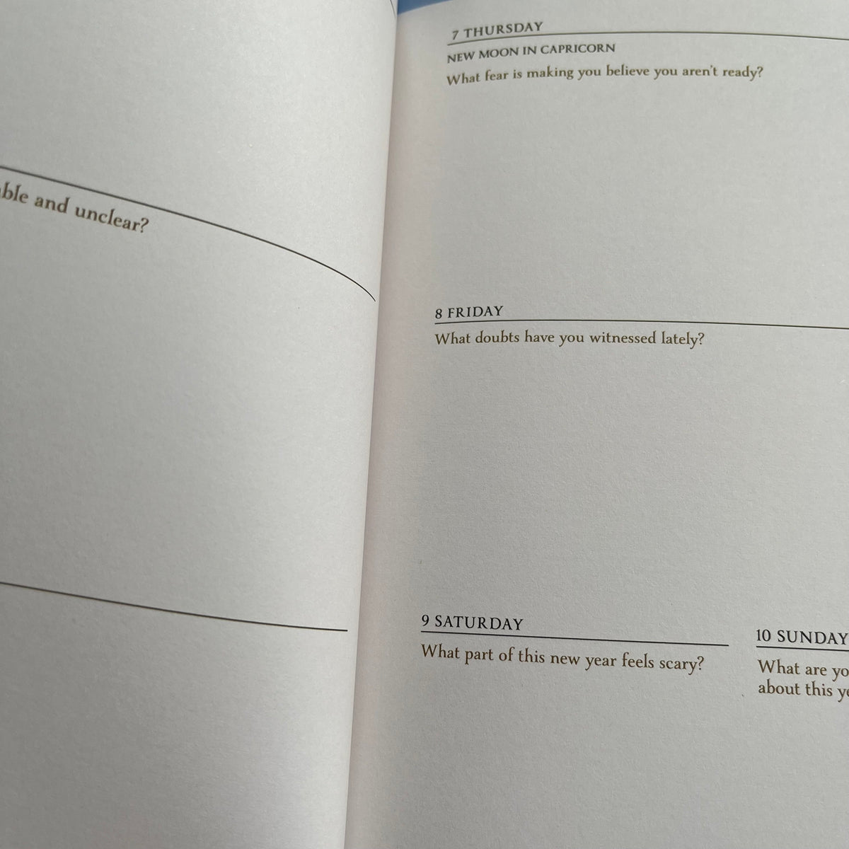 An open book showing printed pages with daily prompts and headings such as Thursday, Friday, Saturday, and Sunday.