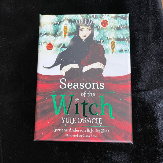 Book titled 'Seasons of the Witch Yule Oracle' on a black background