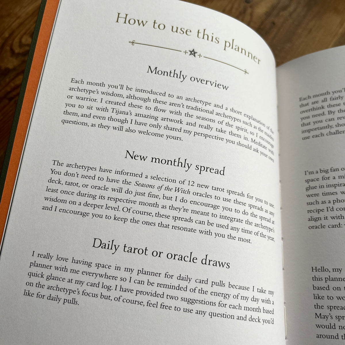 An open book showing printed instructions titled 'How to use this planner' on both pages, photographed close up with a wooden surface visible around the spread.