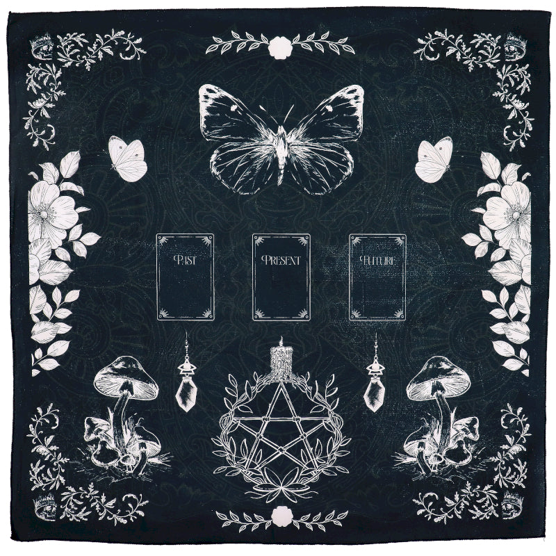 Black Tarot reading cloth with white illustrations of a butterfly, mushrooms, and a pentacle design.