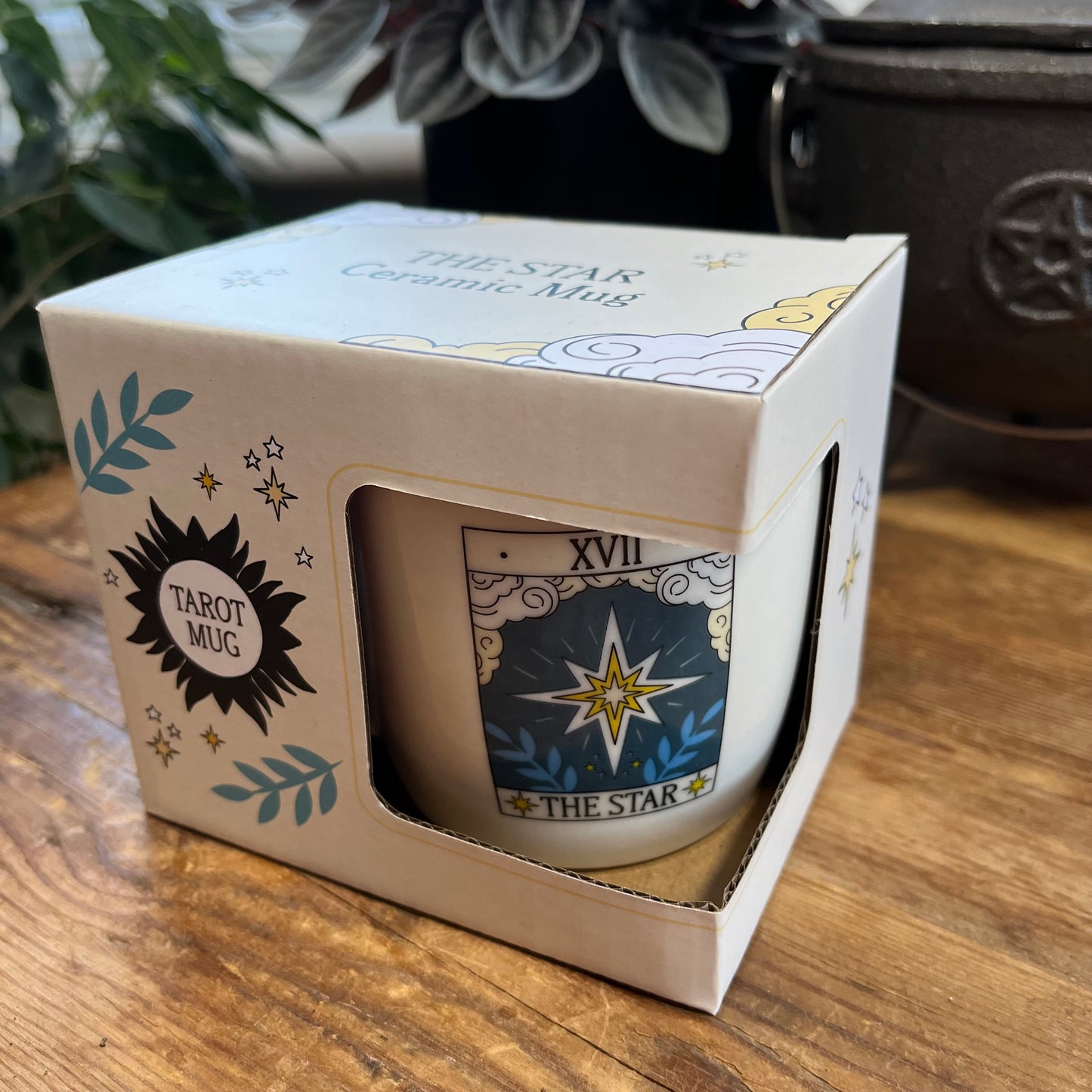Ceramic mug with 'The Star' tarot design in a box on a wooden surface