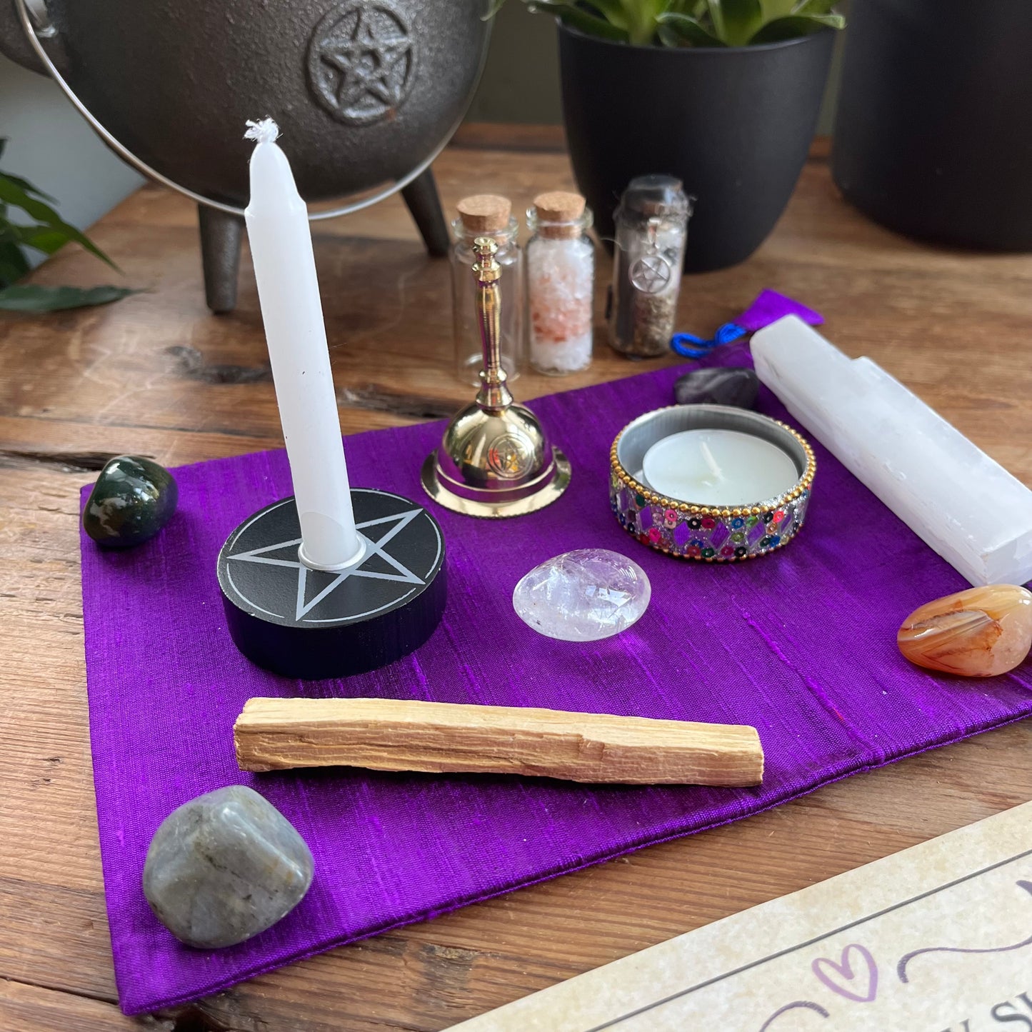 Wiccan or spiritual items on a purple cloth with a pentacle symbol